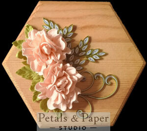 Hexagonal wooden decorative plaque with handcrafted blush pink roses, intricate quilled green leaves, and swirling accents, perfect for home decor or gifting.