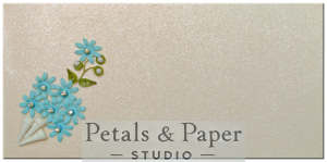 Handcrafted envelope with sky-blue quilled flowers and pearl accents on a shimmering textured background, perfect for weddings, birthdays, and special occasions.