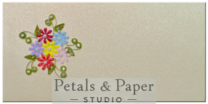 Handcrafted gift envelope with multicolored quilled flowers in red, yellow, pink, purple, and blue, accented by green leaves and rhinestones on a shimmering cream background, perfect for special occasions.