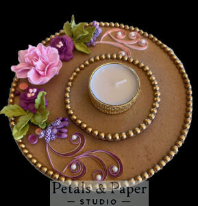 Handcrafted pink and purple floral tea light holder plate with green leaves, quilled details, gold bead edging, and a gold tea light holder for festive home décor.