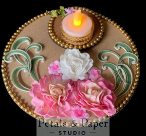 Handcrafted floral tea light holder plate with pink and white roses, green quilled swirls, gold bead edging, and an ornate gold tea light holder for festive home décor.