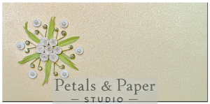 andcrafted 7 x 3.5-inch pearl-textured envelope featuring quilled white roses, green leaves, pearls, and gem accents, ideal for weddings and special occasions.