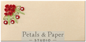 Elegant handcrafted cream quilling card with red roses, green leaves, and sparkling accents for special occasions.