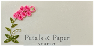Handmade quilled envelope with pink roses, green leaves, and pearl accents, perfect for weddings, birthdays, and festive gifting.