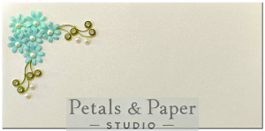 Handmade envelope featuring blue quilled flowers, green leaves, and pearl embellishments, perfect for weddings, festive gifting, and special occasions.