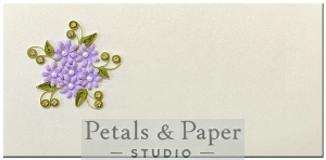Handmade envelope with a star-shaped lavender floral design, green quilled leaves, and pearl accents, perfect for gifting during weddings, festivals, and special occasions.