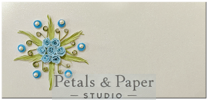 Handmade envelope with a starburst blue rose floral design, green quilled leaves, and pearl accents, perfect for weddings, festivals, and gifting special occasions.