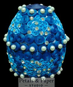 Handmade blue decorative egg with quilling, pearl embellishments, and rhinestone accents, perfect for home décor and gifting.