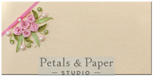 Handcrafted beige gift envelope with pink quilled roses, green leaves, pearls, rhinestones, and a pink ribbon, perfect for weddings, festive gifting, and special occasions.
