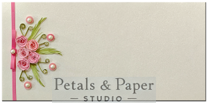 Handmade white gift envelope with pink quilled roses, green leaves, pearls, rhinestones, and a pink ribbon, perfect for weddings, baby showers, and special gifting.