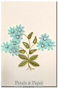 Handmade greeting card with blue quilled flowers and rhinestones – ideal for birthdays, anniversaries, and heartfelt wishes.