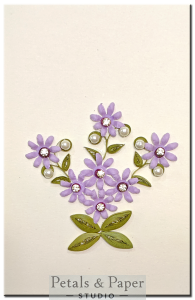 Handmade greeting card with lavender quilled flowers, rhinestones, and pearl accents – perfect for birthdays and special occasions.