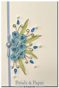 Handmade greeting card with sky-blue quilled roses, pearls, and rhinestones – perfect for baby showers, birthdays, or thank-you gifts.