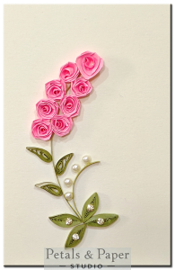 Handmade greeting card with pink quilled roses, pearls, and green leaves on cream base – perfect for birthday and friendship gifts.