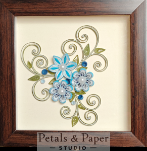 Handcrafted wooden decorative box with blue and white quilled flowers, pearl centers, and green swirls under transparent lid – jewelry and keepsake storage