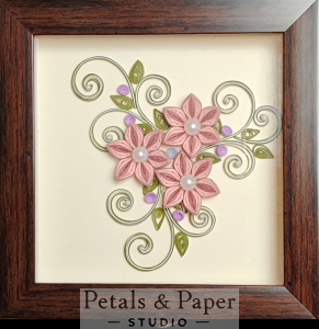 Handcrafted wooden decorative box with pink quilled flowers, pearl centers, green swirls, and lavender sequins under transparent lid – jewelry and keepsake storage