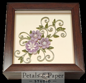 Handcrafted wooden decorative box with lavender quilled flowers, pearl centers, and green swirling vines under transparent lid – jewelry and keepsake storage