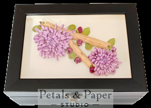 Handcrafted black wooden jewelry box with purple quilled chrysanthemum-style flowers, rosebud accents, green leaves, and glass cover design