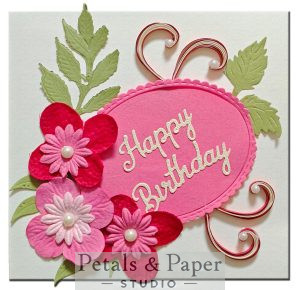 Handmade happy birthday card with layered pink and red paper flowers, quilled heart swirls and pearl embellishments