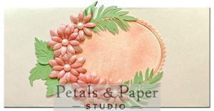 Handcrafted quilled envelope with blush pink paper flowers, green leaf accents, pearl embellishments and oval scalloped frame – luxury handmade gift envelope for weddings and special occasions